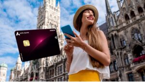 Woman in a straw hat holding a smartphone in a European city square, with the Axis Bank Horizon Credit Card floating beside her.